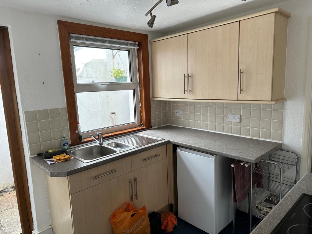 Lot: 77 - TWO-BEDROOM TERRACED HOUSE FOR REFURBISHMENT - Kitchen with access to patio